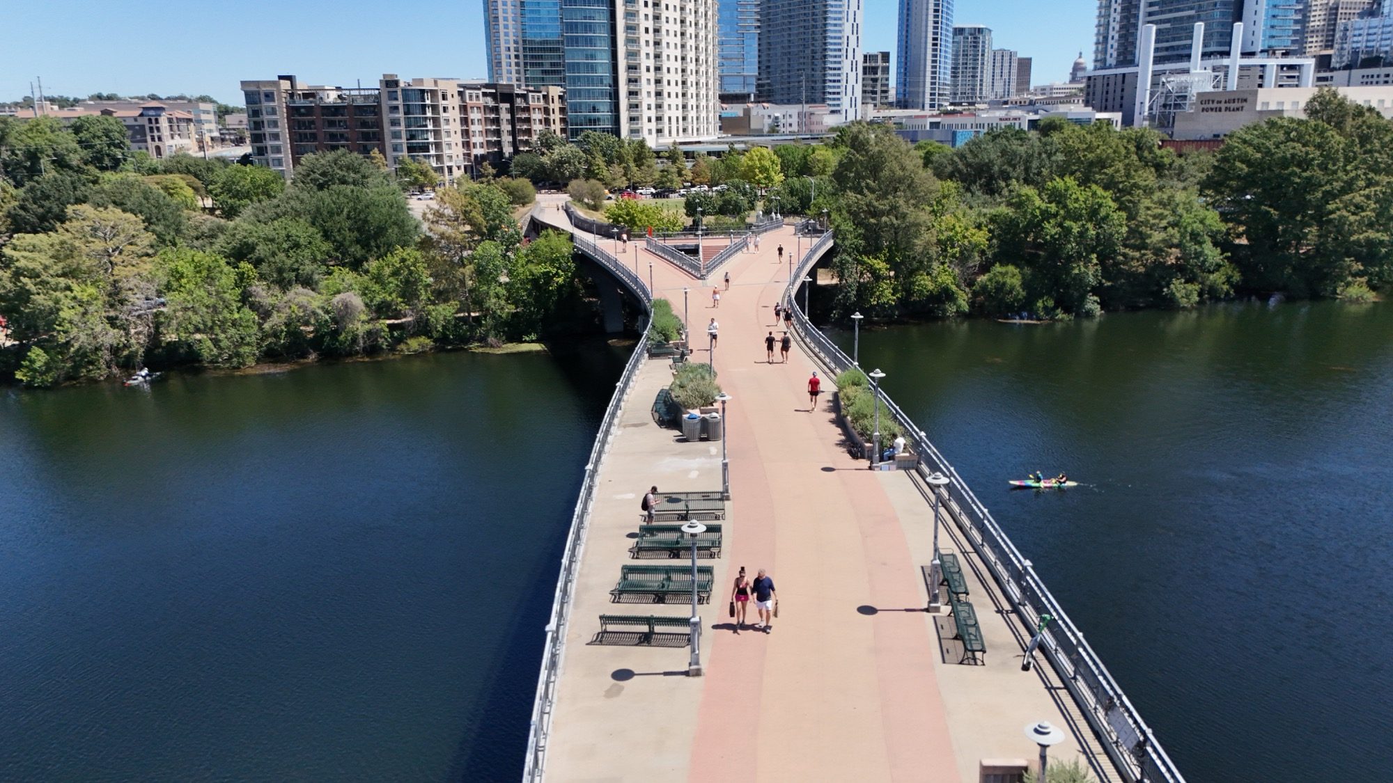 The pedestrian bridge over Lady Bird Lake with downtown Austin beyond